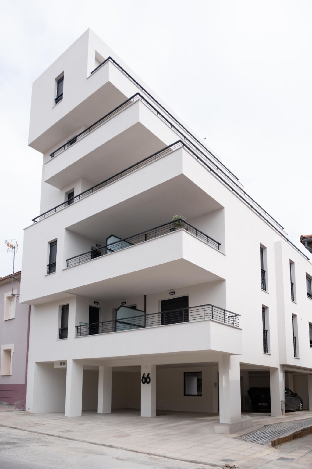 Modern building exterior with covered parking